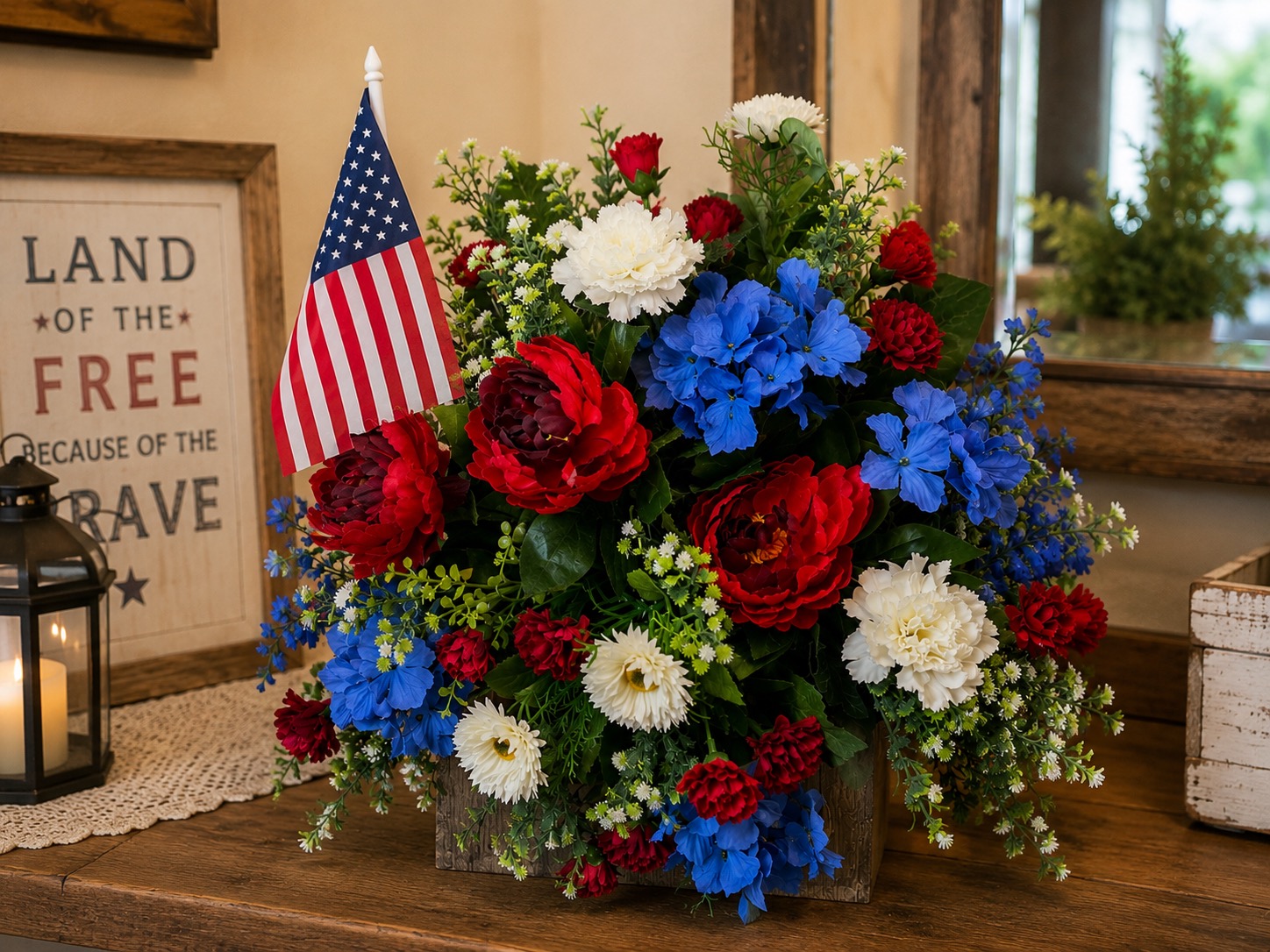 Red white and blue patriotic flower arrangement with an American flag